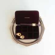 Jewelry box with gold earrings on a white background