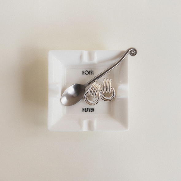 Silver spoon with Mini Knot Silver earrings on Hotel Heaven Mini Ashtray.