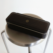 Rectangular jewelry travel case in Onyx on reflective surface.