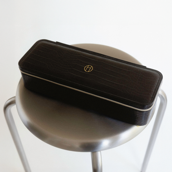 Rectangular jewelry travel case in Onyx on reflective surface.